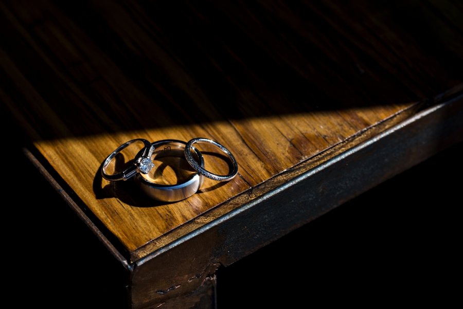 Wedding rings sit in the sunlight.
